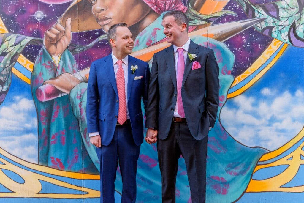 Long View Gallery DC LGBT Wedding Portraits Two Grooms in Blagden Alley with Mural Artwork by Aniekan Udofia