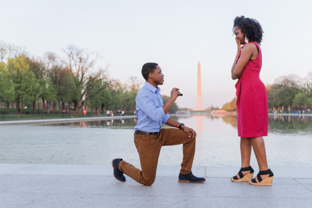 Marriage proposal on the steps of the Lincoln Memorial with the Washington Monument, National Mall, and Reflecting Pool in the background.