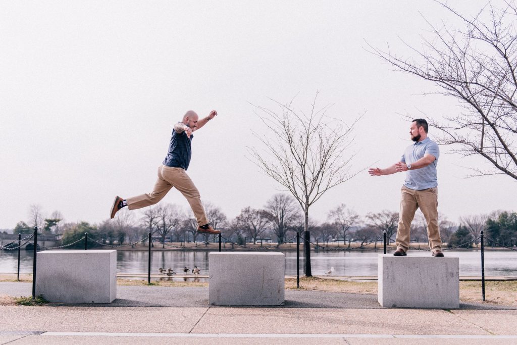 Funny jumping gay engagement shoot on the National Mall in Washington, DC.