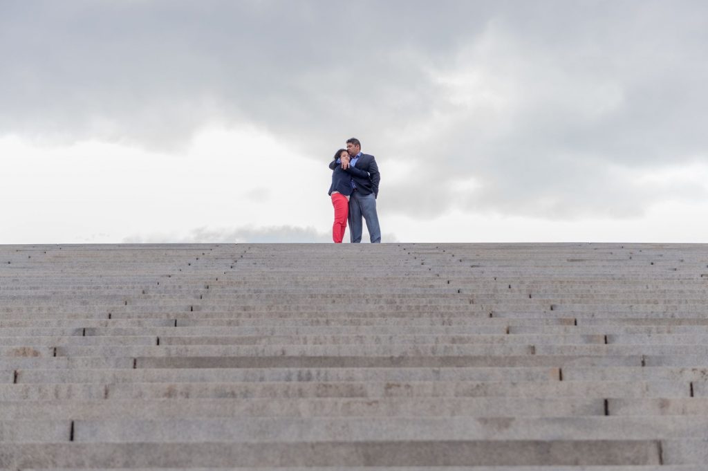 Indian engagement shoot with dramatic skies on the Watergate Steps near the Potomac River in Washington, DC